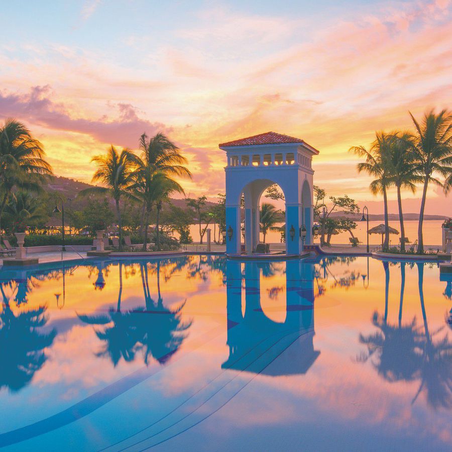 Sunset over an infinity pool at Sandals South Coast, a destination wedding venue in Jamaica