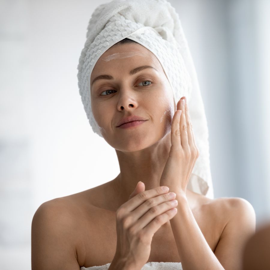 woman applying moisturizer on skin