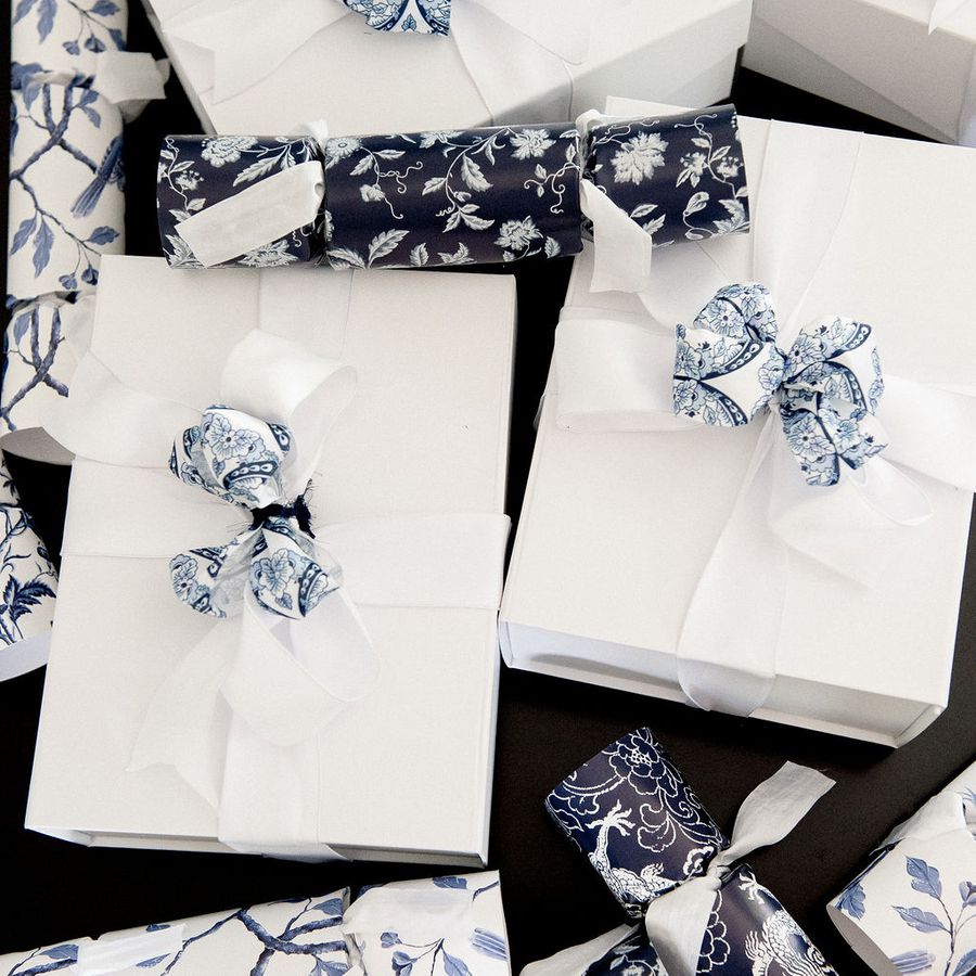 White gifts with chinoiserie-printed bows and crackers